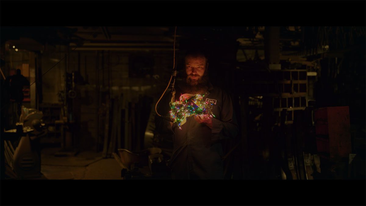 Cole in the workshop with Christmas lights